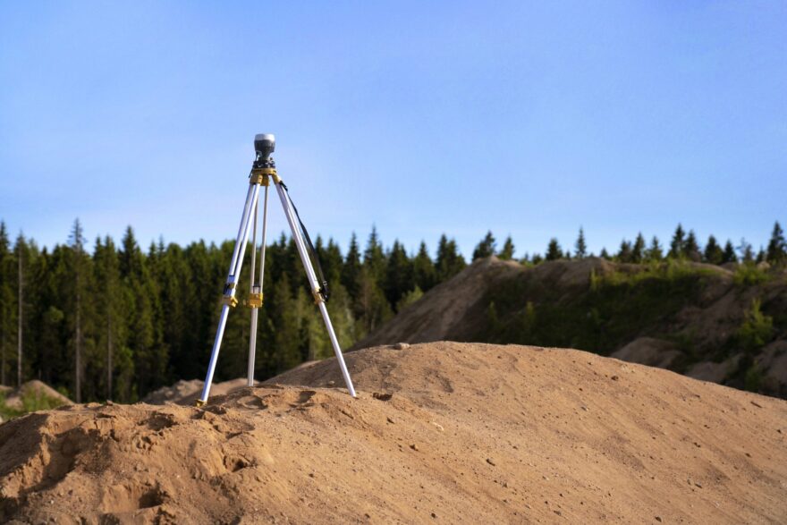 survey equipment on a dirt hill